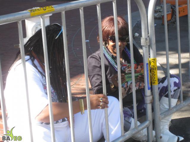 Waiting for the parade and reading a VSK from pre-parade leafleting by Ann, Katherine, Mila, Reeba and Tammy