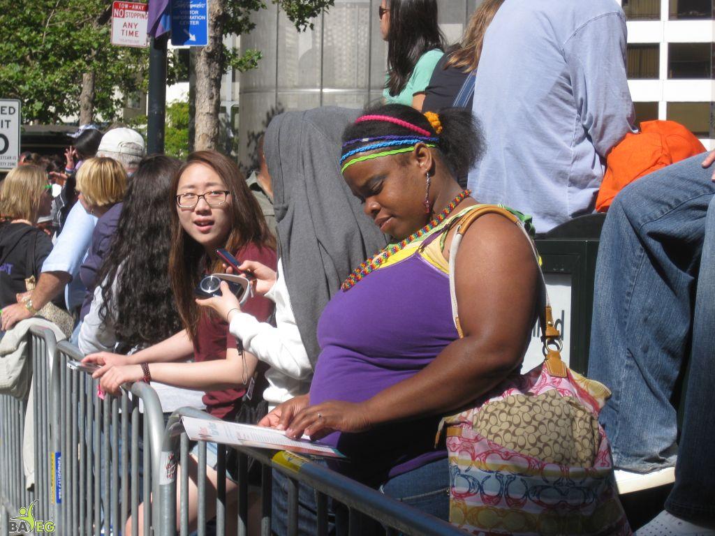 Waiting for the parade and reading a VSK from pre-parade leafleting by Ann, Katherine, Mila, Reeba and Tammy