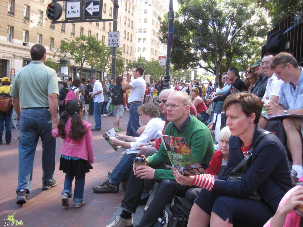 Waiting for the parade and reading a VSK from pre-parade leafleting by Ann, Katherine, Mila, Reeba and Tammy