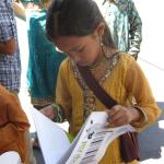 Young reader of PETA's All Animals are Equal at BAVeg booth at the JCNC 10th Anniversary celebration