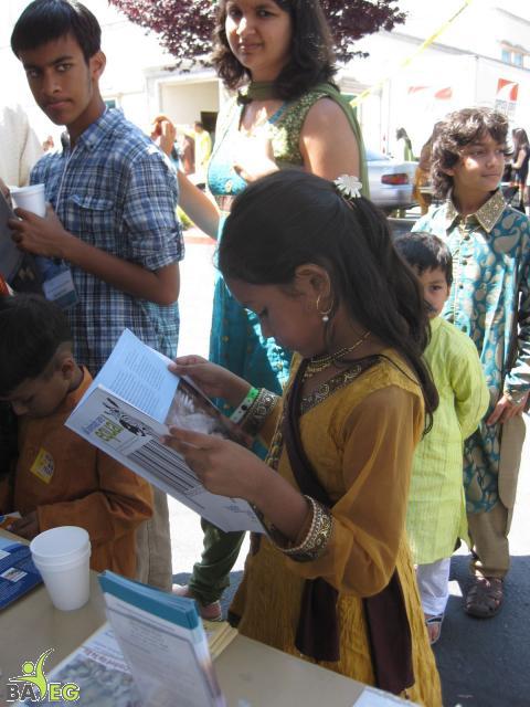 Young reader of PETA's All Animals are Equal at BAVeg booth at the JCNC 10th Anniversary celebration