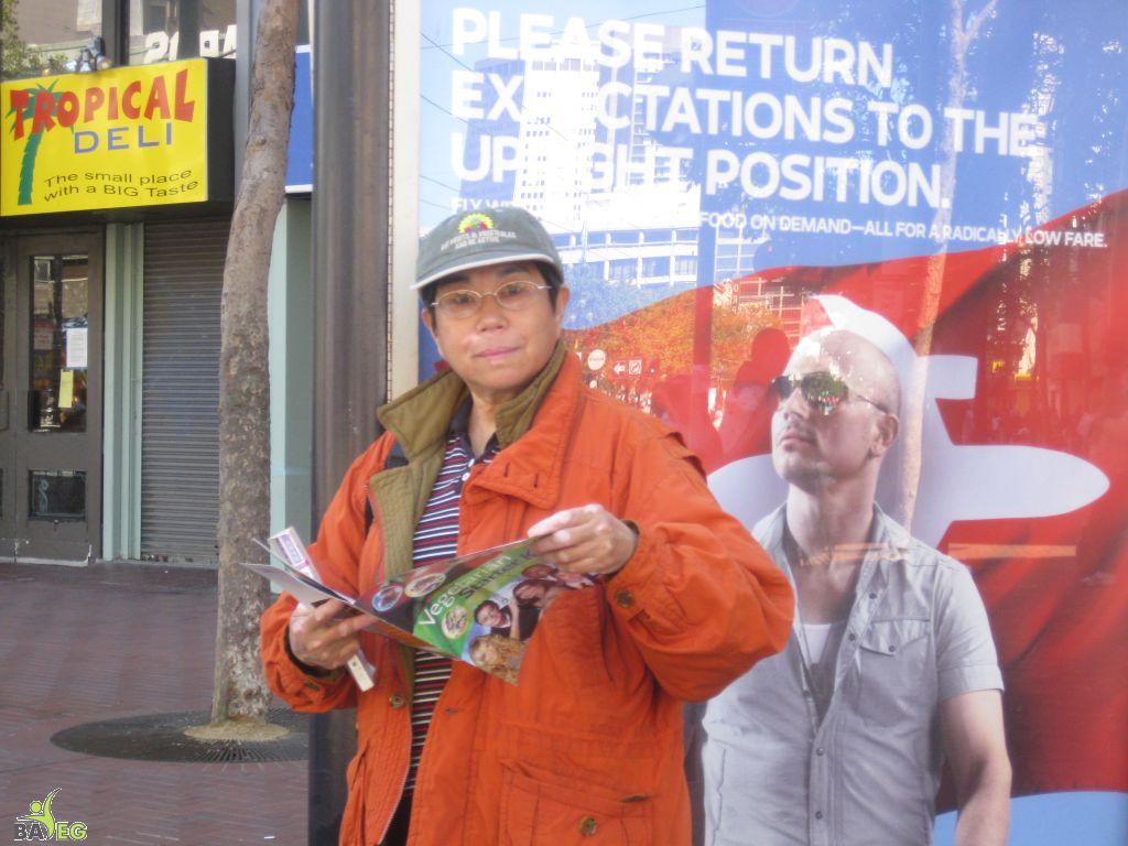 Waiting for the parade and reading a VSK from pre-parade leafleting by Ann, Katherine, Mila, Reeba and Tammy