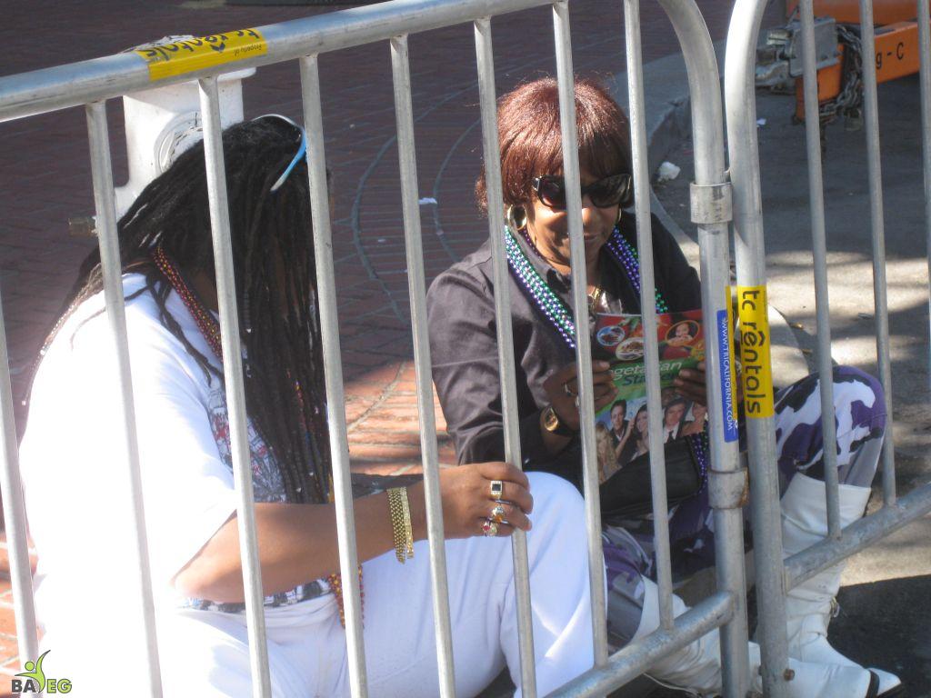 Waiting for the parade and reading a VSK from pre-parade leafleting by Ann, Katherine, Mila, Reeba and Tammy